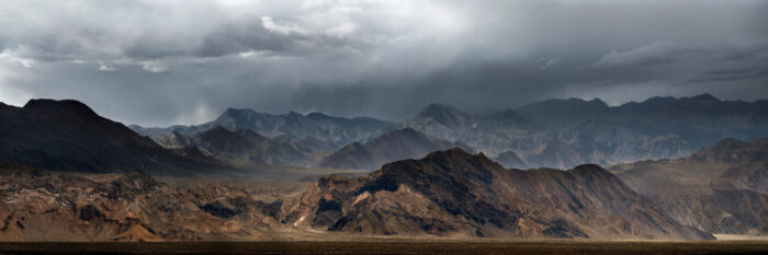 Dark cloud loom over the mountains of death valley