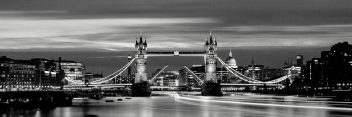 The Tower Bridge raised at night in london city