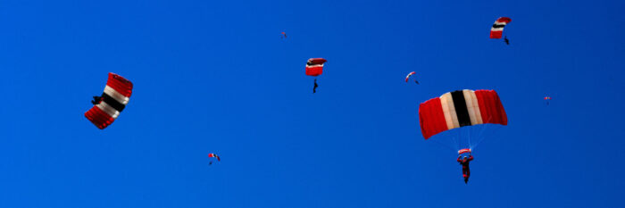 Sky divers with their parachutes open