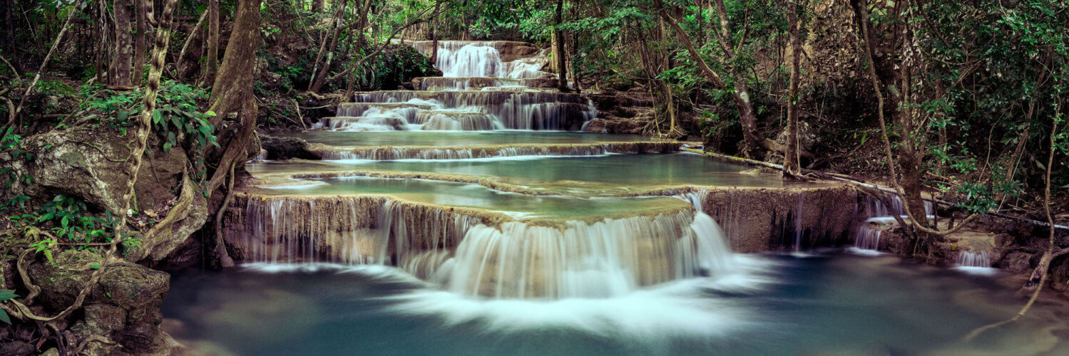 Emerald water flows down the Huai Mae Khamin waterfall
