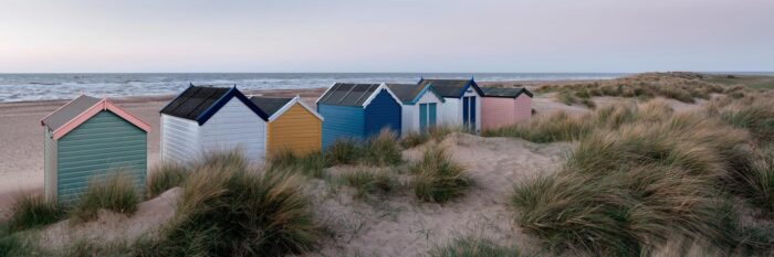 Colourful Beach huts at dawn on an English beach
