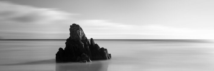 abstract Lone rock on a beach black and white
