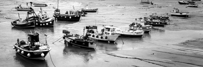 Cornish fishing boats at low tide in St Ives b&w
