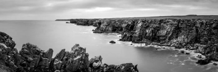 Black and white panorama of the Castlemartin Cliffs in Pembrokeshire