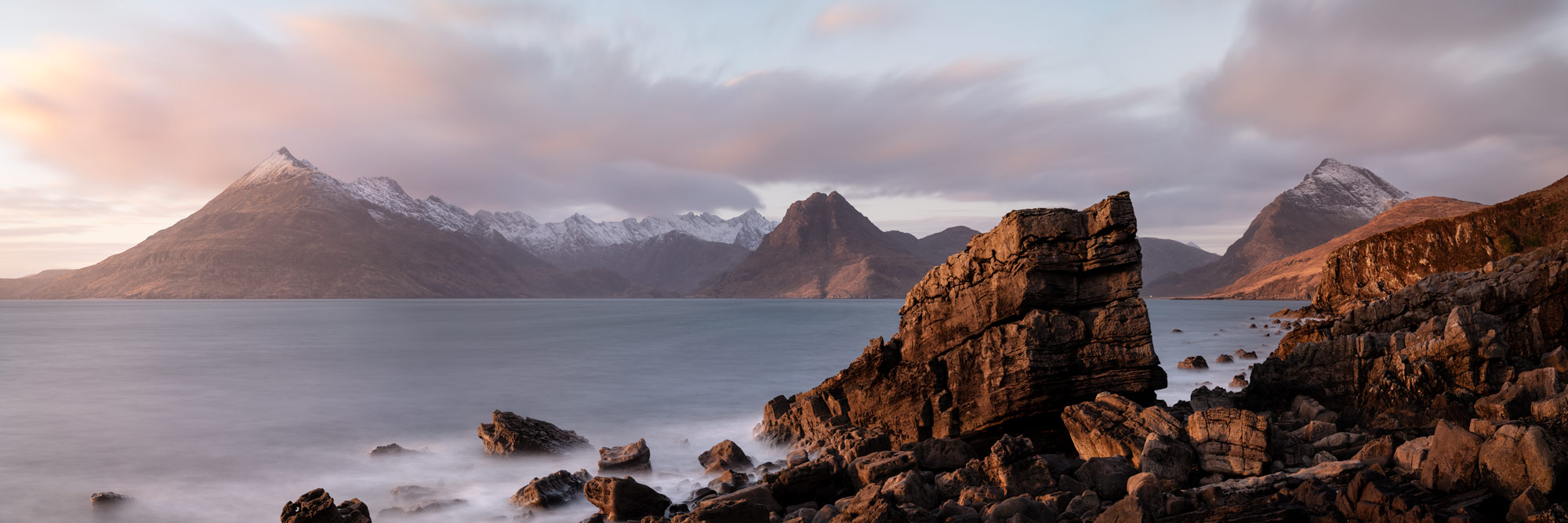 Panorama of the Elgol Coast and Cuillin mountains at sunset on the Isle of Skye