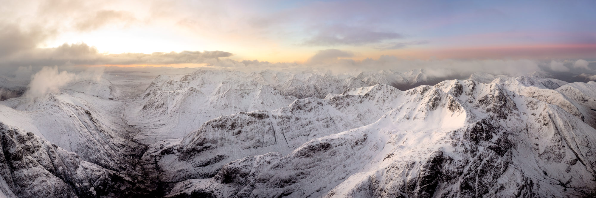 Panorama the three sisters mountains covered in snow at sunrise in Glencoe Scottish highlands