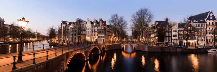 Panorama of the canals and bridges of Amsterdam in The Netherlands at night