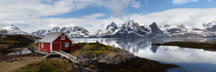 Panorama of a red Boat house in the Lofoten Islands with Lofoten Islands Red Boat house and Trakta mountains and Fjord Austvågøya island