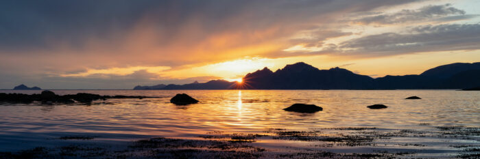 Panorama of the midnight sun with the islands of Vestero on the Vestvagoya coast