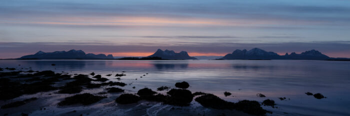 Panorama of Sunset on a beach in Nordland with the isles of Lundøya Engeløya and Skutvika in the distance