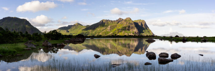 Panorama of a Vestvågøy mountain reflecting in a lake in the Lofoten Islands