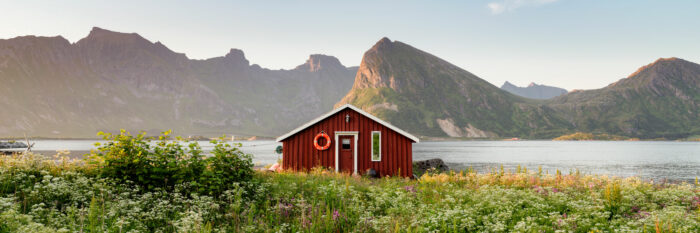 Panorama of red cabin in the Lofoten Islands in summer
