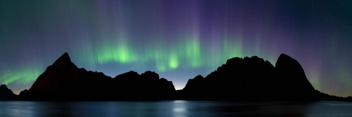 Panorama of the Northern Lights above the mountains in the Lofoten Islands