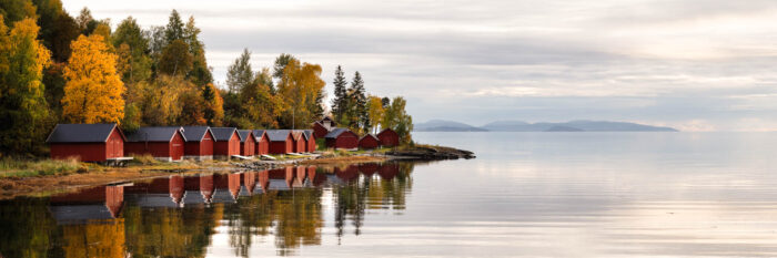 Panorama of red boat houses along the Trondheimsfjorden in Fall in Norway