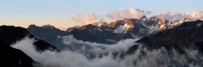 Panorama of Pic Long in the French Pyrenees as the clouds surround the mountains at sunset