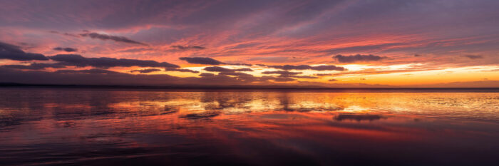 Panoramic Print of a beautiful red sunset on a beach in England