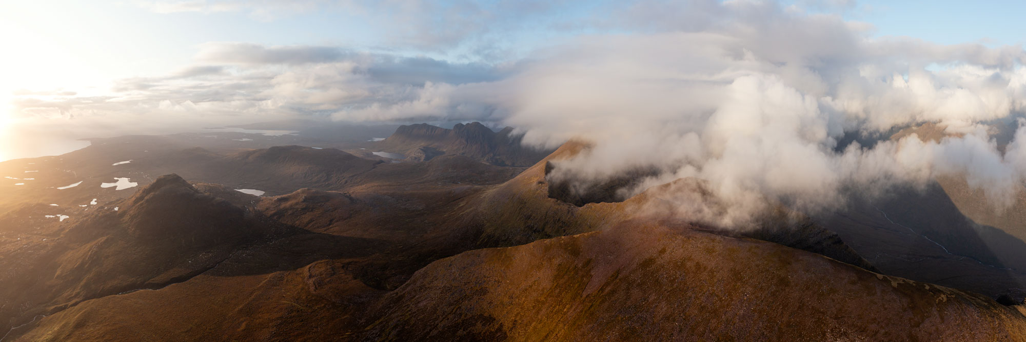 Aerial panorama of Beinn alligin mountain amongst the clouds in Torridon Scotland