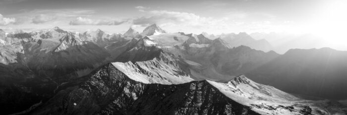 Black and white aerial panorama of the mountain ridges leading to Dent Blanche and Grand Cornier mountains in the Swiss Alps