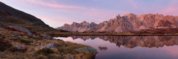 Panorama of the Massif des Cerces reflecting in Lac Long at sunrise in the French Alps