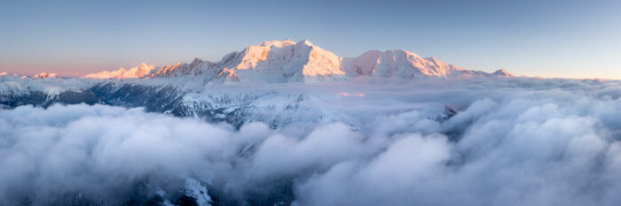 Aerial panorama of Mont Blanc towering above the clouds at sunset