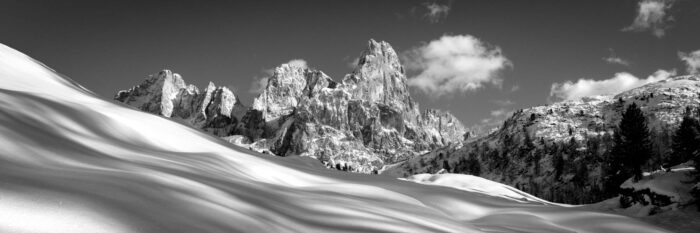 Black and white panorama of snow on Passo Rolle in the Italian Dolomites