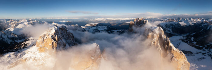 Aerial panorama of the Sassolungo Mountains in the clouds at Sella pass in the Italian Dolomites