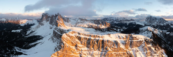 Aerial Panorama of the Seceda Rdigline and Ski area at sunset in the Italian Dolomites