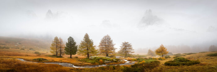 Panorama lost in the mist of Vallée de la Clarée in autumn in the French Alps
