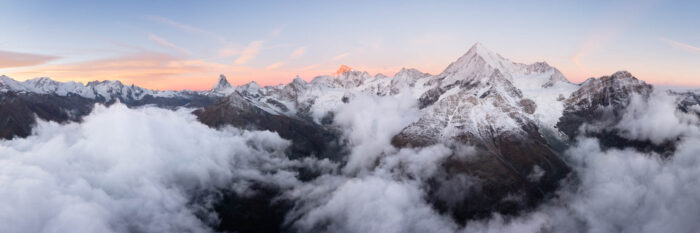 Aerial Panorama of Matter Valley and the Matterhorn during a cloud inversion at sunrise in the Swiss Alps