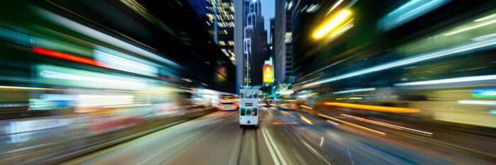 Panoramic print of a Hong Tram speeding though the neon streets at night