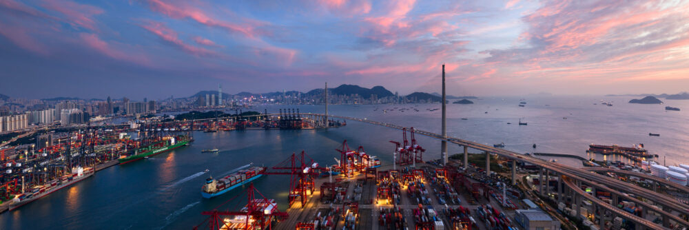 Aerial panoramic view of the Kwai Tsing container terminal and Stonecutters Bridge in Hong Kong at sunset
