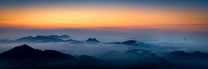 Panoramic print of Hong Kong and Lion Rock lost under a sea of clouds at sunrise from Tai Mo Shan
