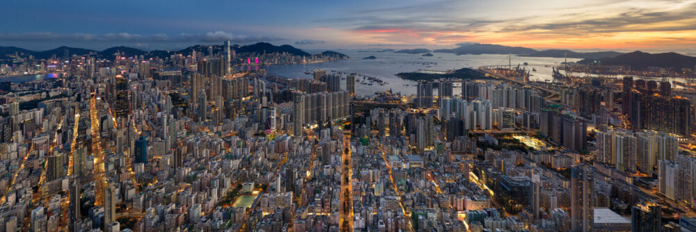 Aerial panoramic print of Sham Shui Po low rise buildings below the Hong Kong Skyscrapers during sunset