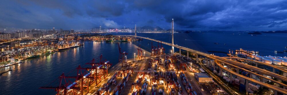Aerial panoramic view of the Kwai Tsing container terminal and Stonecutters Bridge in Hong Kong at night