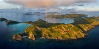 Aerial panoramic art print of a rainbow over Zamami and the Kerama Islands in Okinawa, Japan.