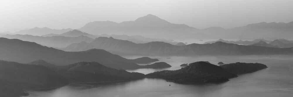 Black and white aerial panorama of San Kung and Plover Cover Mountains and coastline in Hong Kong