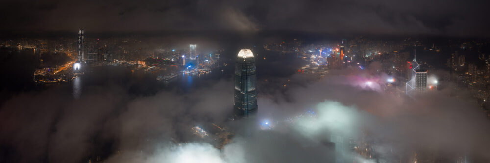 Aerial panoramic photo print of low clouds flowing though the Hong Kong Skyline at night