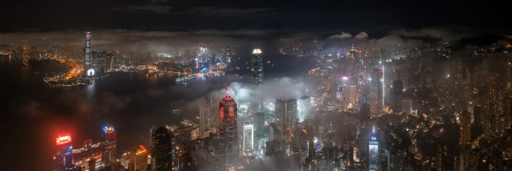 Aerial panorama art of the Hong Kong Skyline shrouded in fog at night