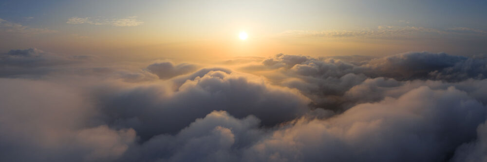 Aerial Panorama flying high above a sea of clouds