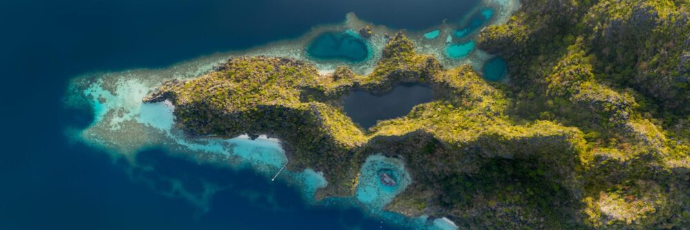 Aerial panorama above the blue lagoons of Coron Island in Palawan, Philippines