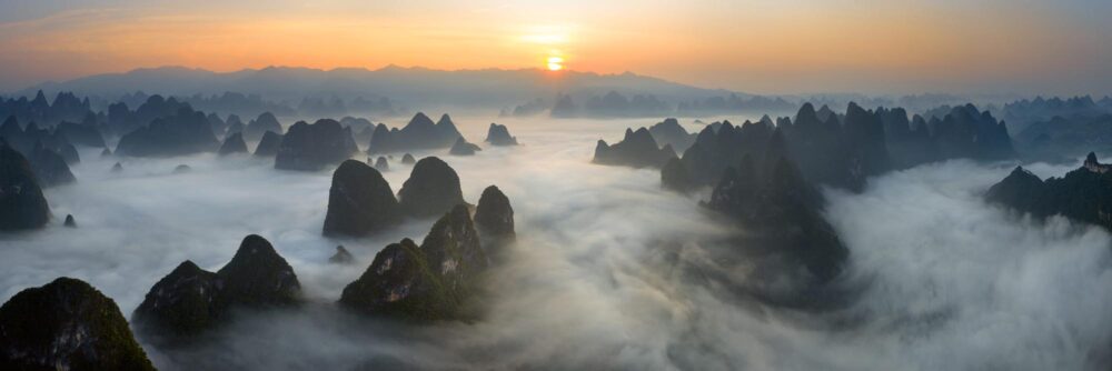 Aerial panorama of a sea of clouds above the River Li in Xingping Yangshuo China at sunrise