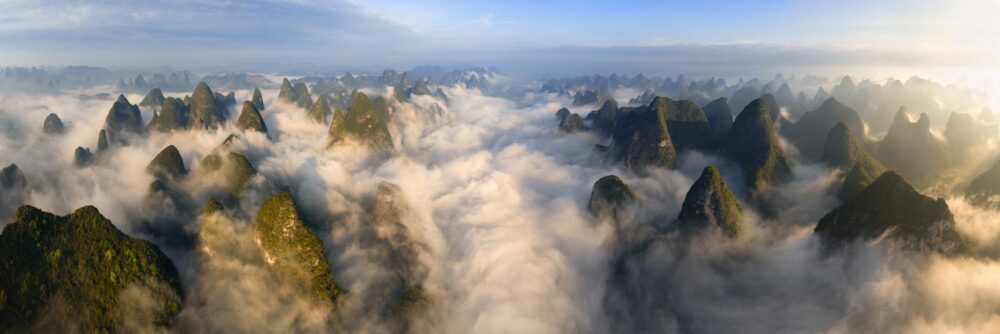 Aerial panorama of a sea of clouds flowing through the Yulong River Valley in Yangshuo China
