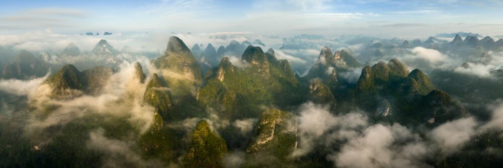 Aerial Panorama of the Yangshuo Karst Mountains shrouded in clouds in Guilin China