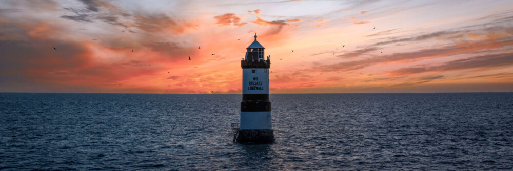 Panorama of the Trwyn Du Lighthouse at sunset in Penmon Point, Anglesey, Wales